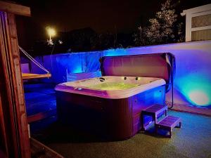 a bath tub with purple lights in a room at Captivating 4-Bed Hot Tub House in Blackpool in Blackpool