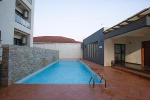 a swimming pool in front of a building at The Gem in Accra