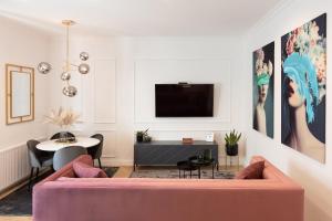 Una sala de estar con un sofá rosa y una mesa. en Candy Ballerina No 1 Zagreb Center - top positon Lux, en Zagreb
