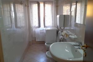 a bathroom with a sink and a toilet and a shower at DEA 2 in Seriate