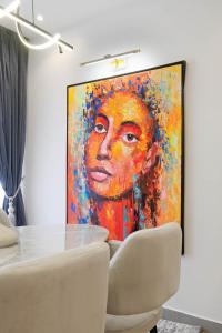 a painting of a woman on a wall at Luxury 3 Bed Serviced Apartment in Lekki Phase 1 in Lagos