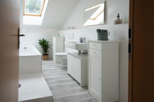 a white bathroom with a sink and a toilet at CaSa Apartment Svea - 2x Parken-Amazon Prime-Terasse-Garten-Vollausstattung in Erfurt