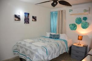 a bedroom with a bed and a ceiling fan at Casas Calis Cancún in Cancún +126 photos