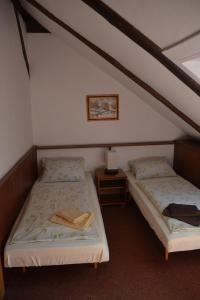 two twin beds in a room with at Pension U akátu in Prague
