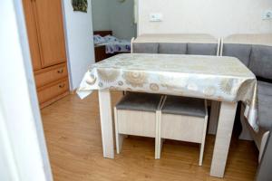 a dining room table with two chairs and a table with a white table cloth at Leila in Tbilisi City
