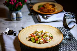 a plate of food with vegetables on a table at Zen Resort Sahl Hasheesh by TBH Hotels in Hurghada