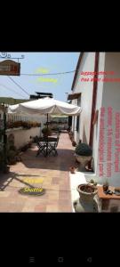 a patio with a table and an umbrella at B&B PompeiLog in Pompei