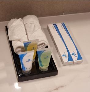 a bathroom counter with three cups and a towel at Shaqa at Address Beach Residence - Fuj in Fujairah