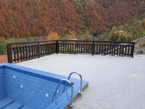 a large patio with a wooden railing on a deck at Vila Kula in Crni Vrh
