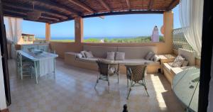 a living room with a couch and a table at La Terrazza sul Mare in Fort Village