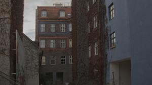 a tall brick building in the middle of two buildings at Blue Lotus Apartment in Vienna