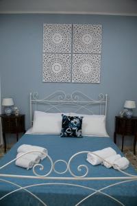 a blue bedroom with a bed with two pillows at I MORI in Santa Teresa di Riva
