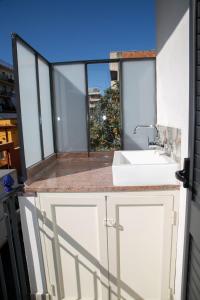 a bathroom with a sink and a window at I MORI in Santa Teresa di Riva