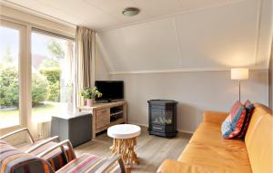 een woonkamer met een bank en een open haard bij Awesome Home In Vlagtwedde With Kitchen in Vlagtwedde