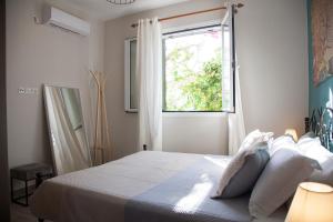 Postel nebo postele na pokoji v ubytování Casa da Bugainvillea