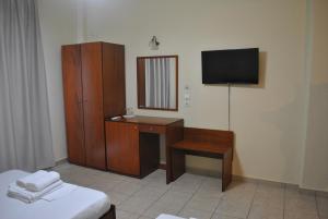 a hotel room with a desk and a television at Anesis in Platamonas