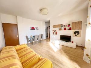 a living room with a couch and a table with chairs at Lovely apartment a due passi dal mare in Rimini