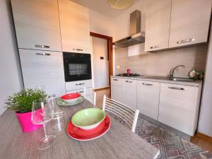 a kitchen with a table with red and green plates on it at Lovely apartment a due passi dal mare in Rimini