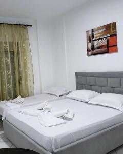 2 camas individuais num quarto com uma janela em DREAM APARTMENT Vlore em Vlorë