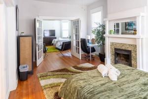 a bedroom with a bed and a fireplace at The Great Pink Lady with Huge Wrap Around Porch! in Richmond