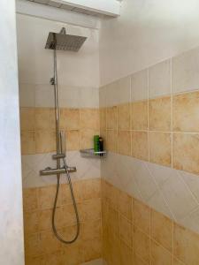 a shower with a hose in a bathroom at Elmani in Pozzallo