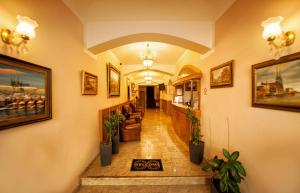 a hallway in a building with potted plants at Hotel Askania in Prague