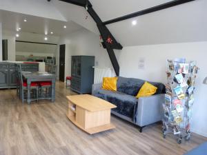 a living room with a couch and a table at T2 calme et chaleureux 1 à 5 pers in Alençon