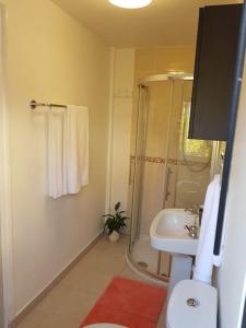 a bathroom with a shower and a sink at Cosy London holiday Home (Near O2 arena) in London