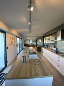 a large room with a kitchen and a living room at La maison des Rimains in Cancale