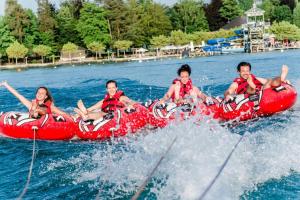 a group of people on a raft in the water at Lakeside Apartment - Velden in Velden am Wörthersee