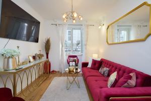 a living room with a red couch and a mirror at Old town Casa Nevia Dubrovnik in Dubrovnik