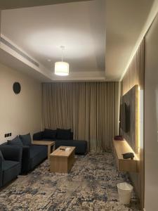 a living room with a couch and a tv at Golden New Quraish Jeddah in Jeddah