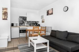 a living room with a couch and a table at Pension Genat in Wedemark