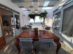 a wooden table and chairs on a patio at Agnanti Hotel in Adamantas