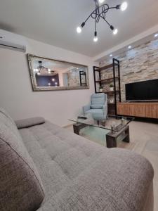 a living room with a couch and a television at M Lux Apartments in Banja Luka