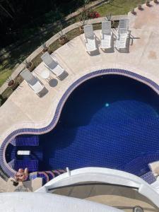 an overhead view of a large swimming pool with lawn chairs and sidx sidx at Private villa, pool with ocean view and sounds in Puerto Vallarta