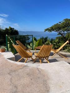 a group of wooden benches sitting next to a gate at Private villa, pool with ocean view and sounds in Puerto Vallarta