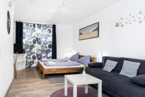 a living room with a couch and a table at Pension Genat in Wedemark