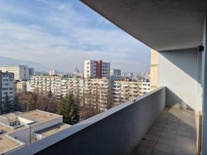 a view of a city from the balcony of a building at Very Spacious & Modern 3Bed near Airport & Centre in Sofia