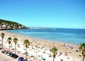 a beach with a lot of people and the ocean at Casa playa hermosa frente al mar in Playa Hermosa