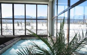 a room with a jacuzzi tub in a building with snow at Apartaments by Zenit in Terra Complex B16 & C18 near Bansko in Razlog