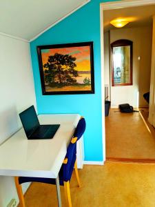 a room with a desk with a laptop on it at Central studio apartment in Gothenburg