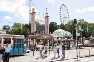 a group of people standing in front of a amusement park at Central studio apartment in Gothenburg