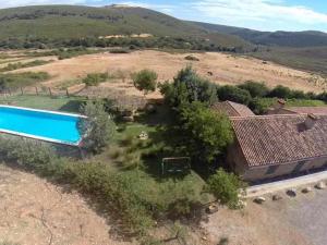 an aerial view of a house with a swimming pool at La Alberguería complejo rural in Cañamero