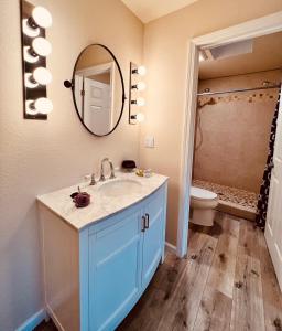 a bathroom with a sink and a toilet and a mirror at West Sonoma Inn & Spa in Guerneville