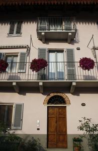 a building with two balconies and a wooden door at Cà Veja in Montà