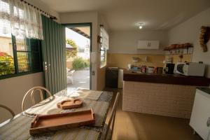 a kitchen with a table with a purse on it at Hospedaria Recanto da Val in Passa Quatro