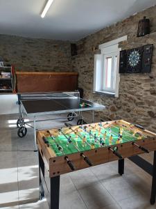 a ping pong table in a living room with at CASA RURAL PAJARICA en Sanabria in San Ciprián