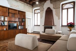 a living room with a couch and chairs and a fireplace at Casa Turandot Verona in Verona