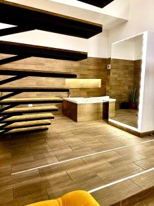 uma casa de banho com pisos em madeira e um lavatório em Elegante loft con jacuzzi privado em Quito